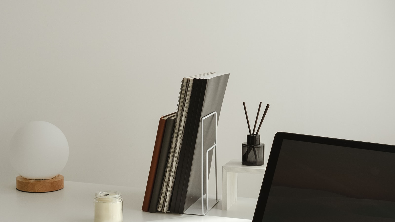 A compact desk setup fitted into the corner of a small bedroom